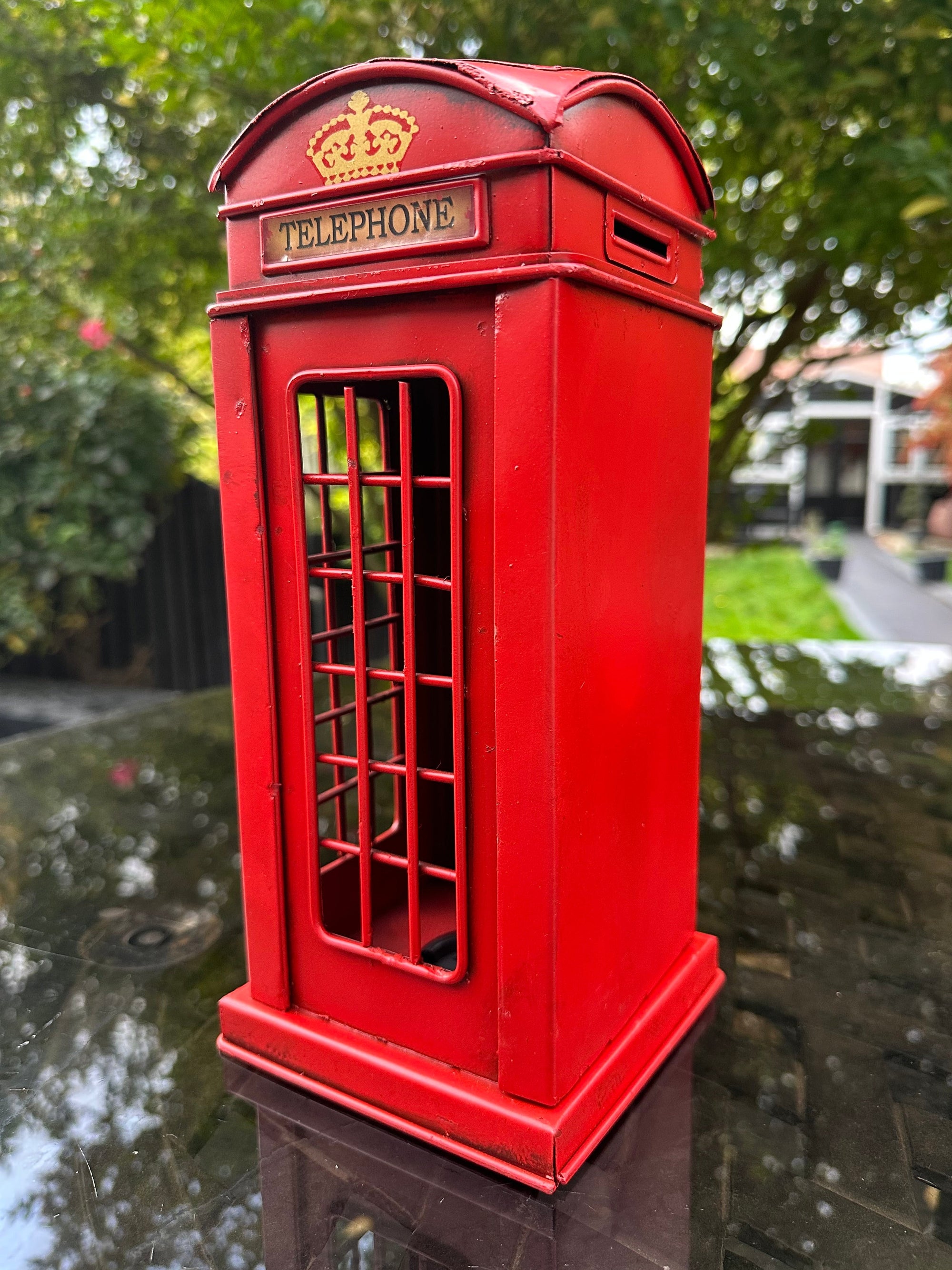 Red telephone booth with a 'Telephone' label
